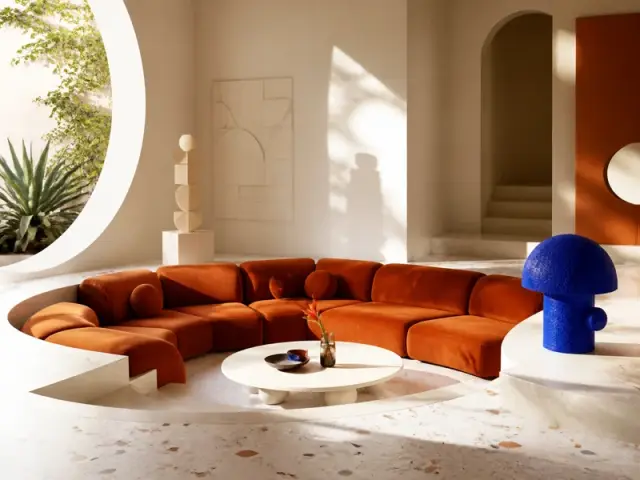 Sculptural living room with an orange sofa and cobalt-blue lamp