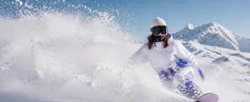Snowboarder emerging from a cloud of powder